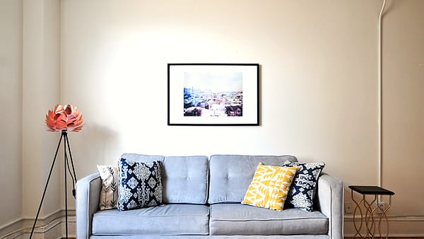 A room at home in Boston, United States, its furnishings and shelves lit by daylight from the window