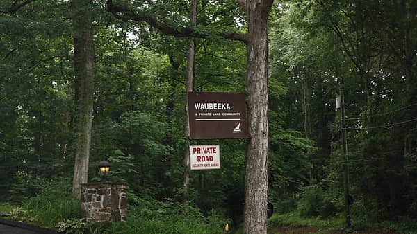 The entrance sign at Lake Waubeeka in Danbury, Connecticut, standing at the road into the community