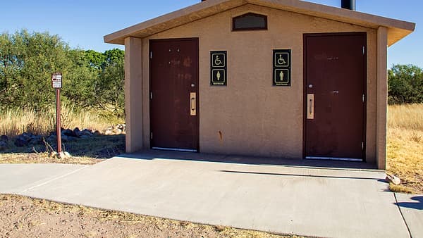 An accessible bathroom with grab rails and a wide turning space, built near Empire Ranch in Arizona