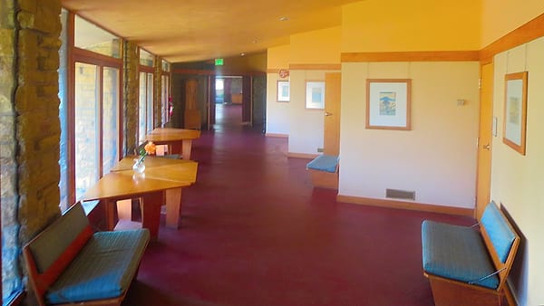 A hallway of meeting offices at the First Unitarian Society, doors running along one side of the corridor