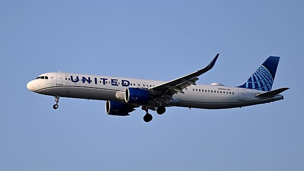 An airliner on final approach to Runway 27 at Boston Logan International Airport with its landing gear down