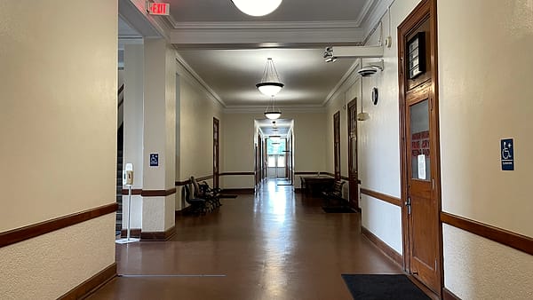 A first floor hallway inside the Madison Parish Courthouse in Tallulah, Louisiana, with doors along one side