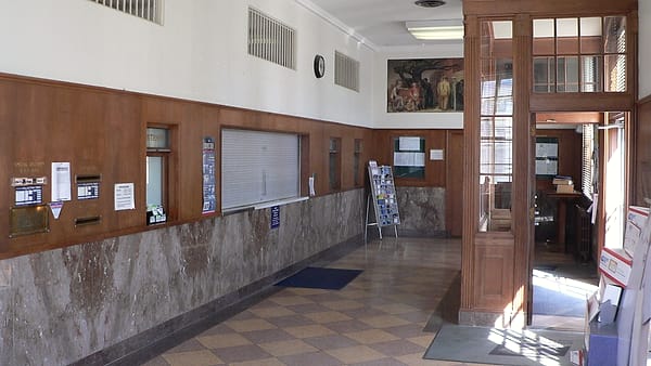 The interior of the post office at Pawnee City, Nebraska, with its wood-and-glass lobby to one side