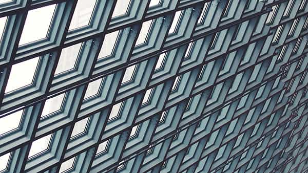 The glass and steel exterior of the Central Library in downtown Seattle, Washington, rising above the street