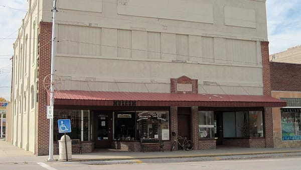 The brick exterior of the Adams Block in downtown Crawford, Nebraska, seen along the street front