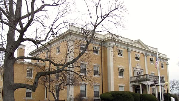The Administration Building at McLean Hospital in Belmont, Massachusetts, seen across the lawn in front of it