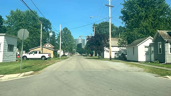 A residential street in Arlington, Ohio, with houses set back behind lawns on either side