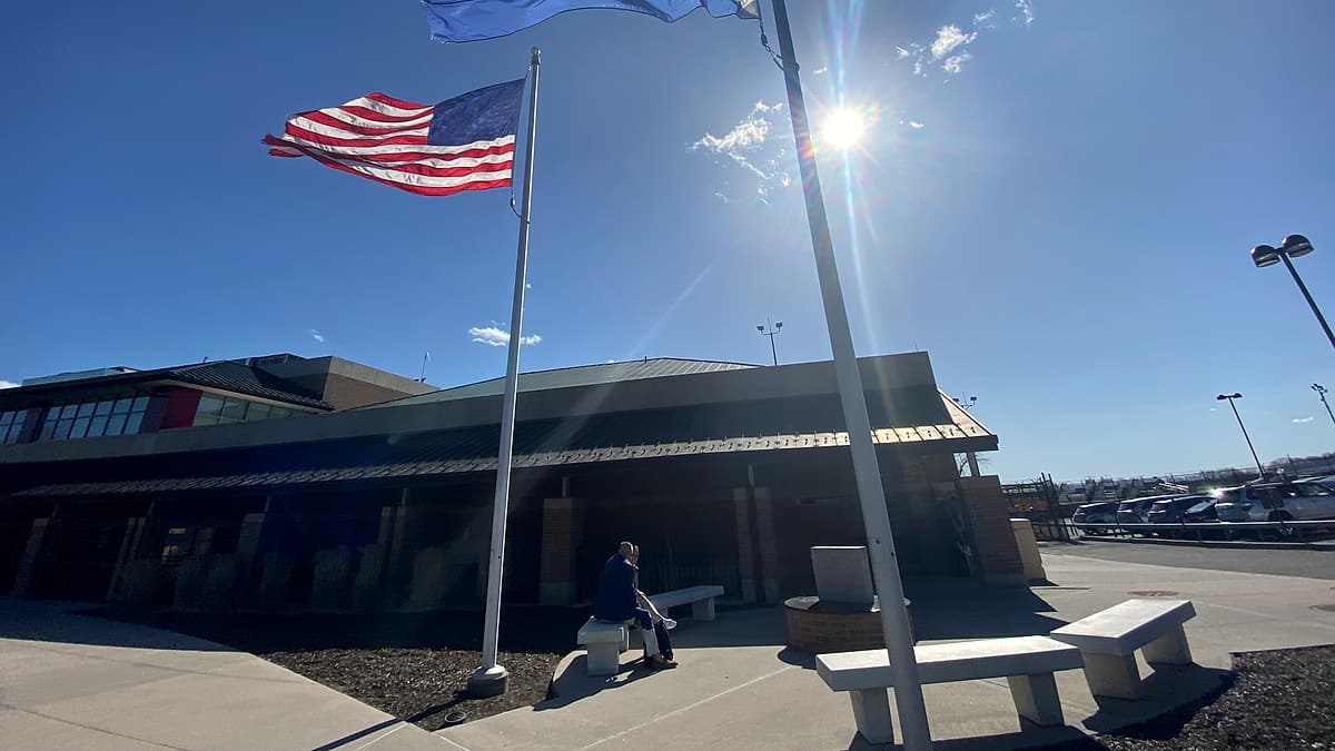 The flags of the United States and Westchester County flying beside the terminal at Westchester County Airport