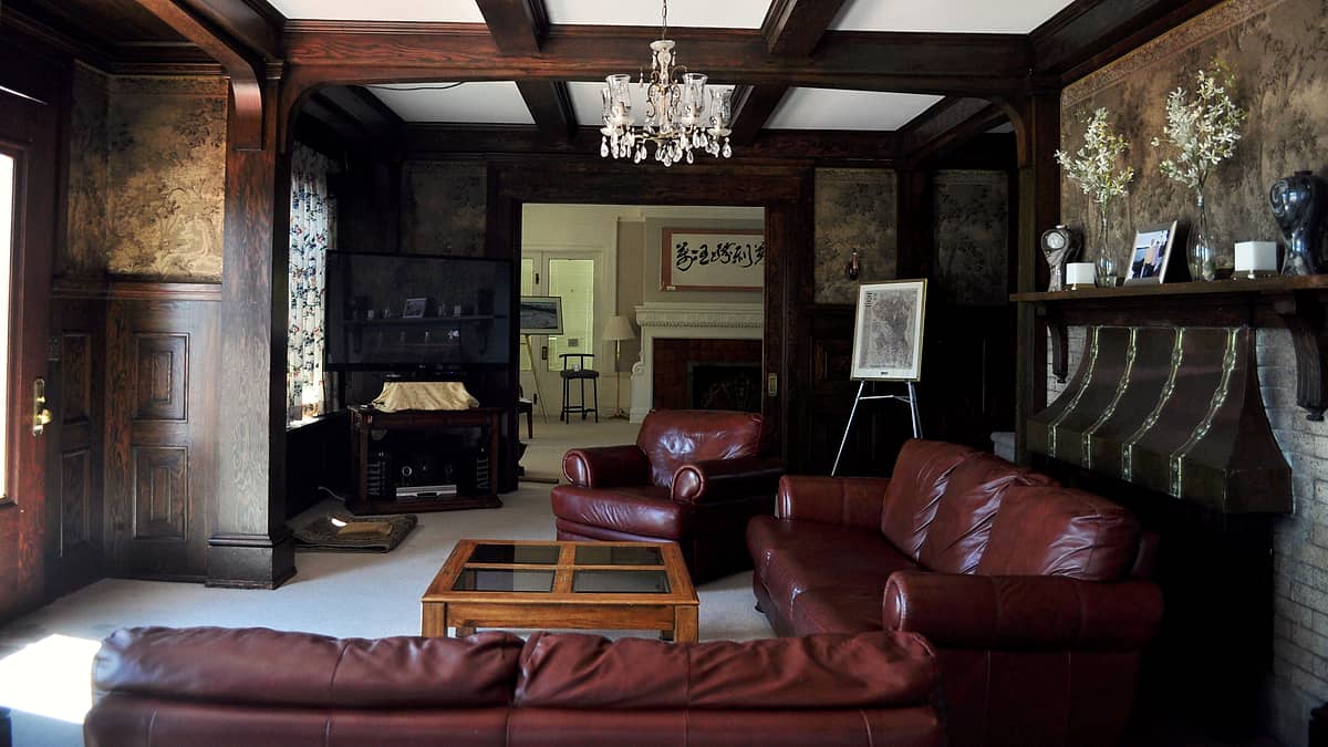 The living room of Lochkelden in the Windermere neighborhood of Seattle, Washington, with its fireplace and panelling