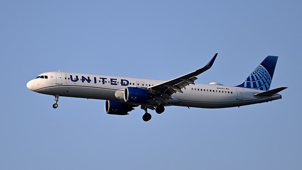An airliner on final approach to Runway 27 at Boston Logan International Airport with its landing gear down
