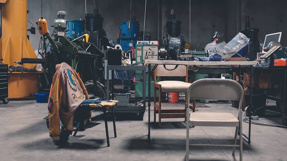 A man at work in a cluttered workshop in Las Vegas, United States, surrounded by tools and materials
