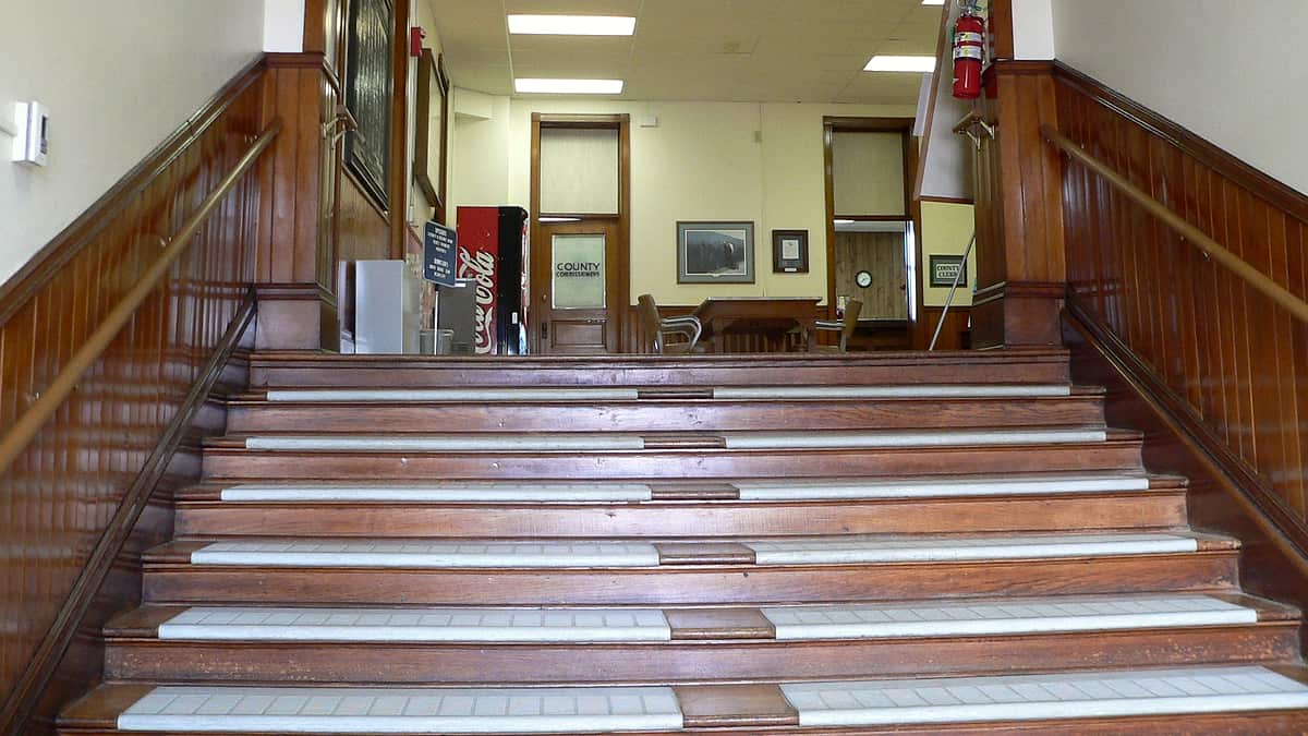 The interior stairs of the Wayne County Courthouse in Wayne, Nebraska, rising from the main entrance