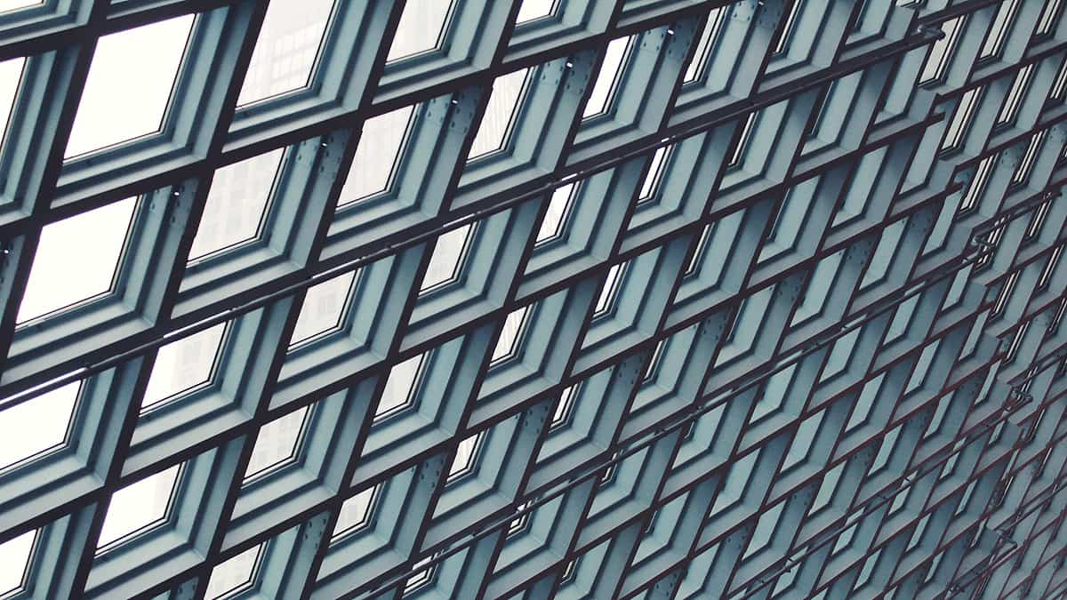 The glass and steel exterior of the Central Library in downtown Seattle, Washington, rising above the street