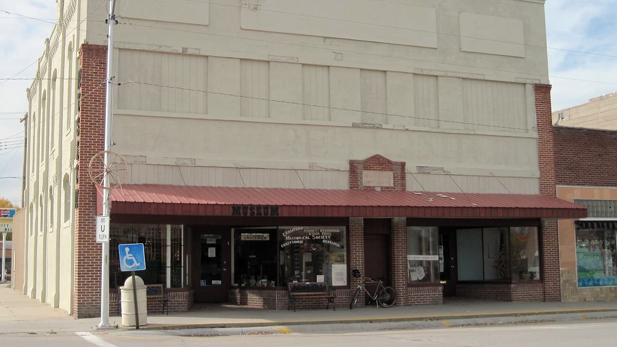 The brick exterior of the Adams Block in downtown Crawford, Nebraska, seen along the street front